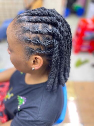 Finished loc bun styled at Mufasa Locs