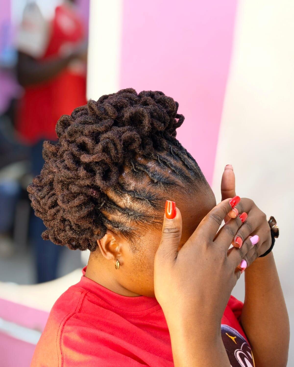Client at Mufasa Locs with burgundy box braids and beaded ends